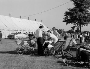 Dagenham Town Show 1970, showing family resting in deckchairs by tree and marquee in background, 1970