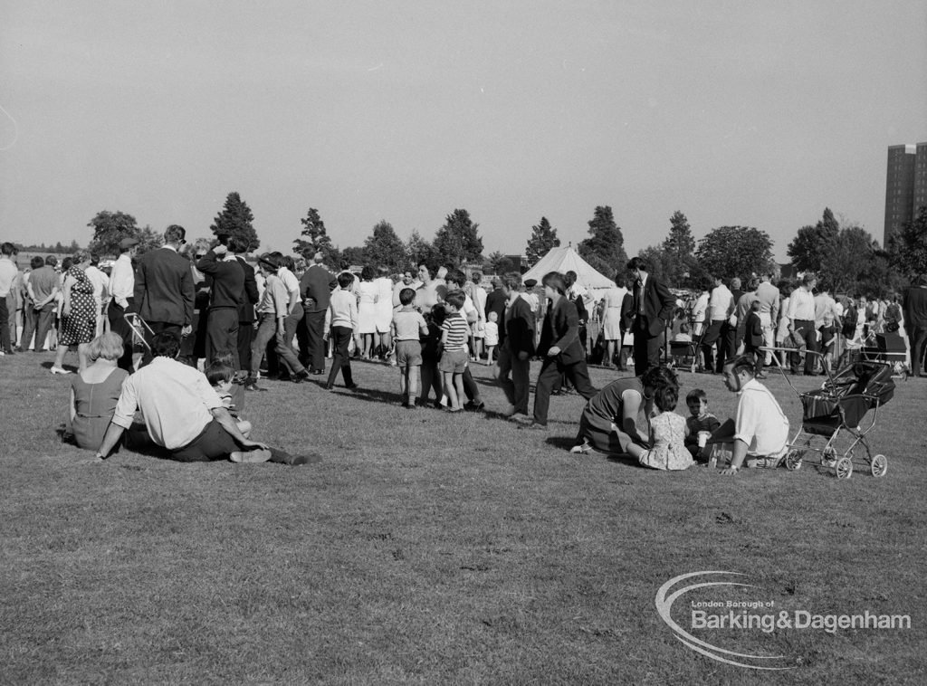 Dagenham Town Show 1970, showing group of visitors resting on grass, and others lining small arena, 1970