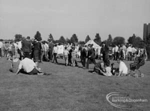 Dagenham Town Show 1970, showing group of visitors resting on grass, and others lining small arena, 1970