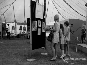 Dagenham Town Show 1970, showing Arts display, with visitors looking at display of paintings in ‘studio’, 1970