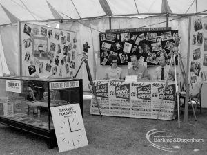 Dagenham Town Show 1970, showing Fanshawe Film Society stand, with officers sitting and cameras and stills on display, 1970