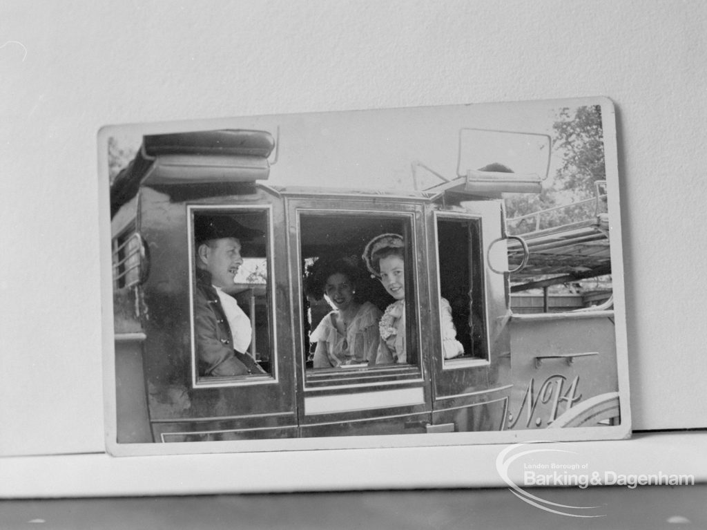 Photographic negative copy of old Valence House Museum photograph, showing man and woman in eighteeneth century costume at coach window, 1970