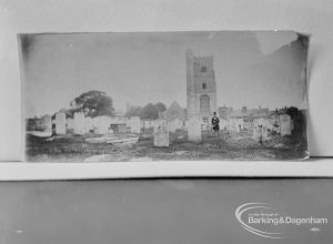 Photographic negative copy of old Valence House Museum photograph, showing tombstones and man in Churchyard at St Margaret’s Parish Church, Barking, 1970