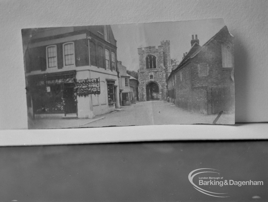 Photographic negative copy of old Valence House Museum photograph, showing the Curfew Tower at Barking Abbey, seen between buildings in East Street, 1970