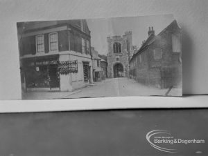 Photographic negative copy of old Valence House Museum photograph, showing the Curfew Tower at Barking Abbey, seen between buildings in East Street, 1970