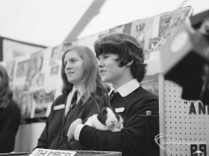 The Duke of Edinburgh’s visit to Cambell School, Langley Crescent, Dagenham, showing two girls standing by display, one holding a rabbit, 1970