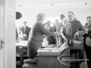 Welfare, with the introduction of bus permits for certain elderly people, showing woman receiving permit during first day of issue, 1971