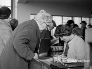 Welfare, with the introduction of bus permits for certain elderly people, showing permit being prepared by member of staff during first day of issue, 1971