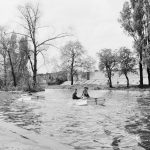 The Boating Lake at Barking Park, Barking, showing two boys in boat, island and trees, 1971