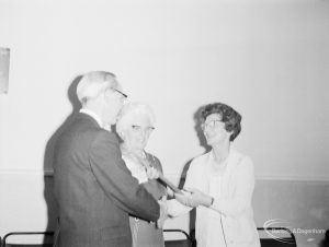 London Borough of Barking Libraries Department staff, showing Mr William McKenzie at his retirement, with Mrs McKenzie and Alderman Mrs Thomas, 1971