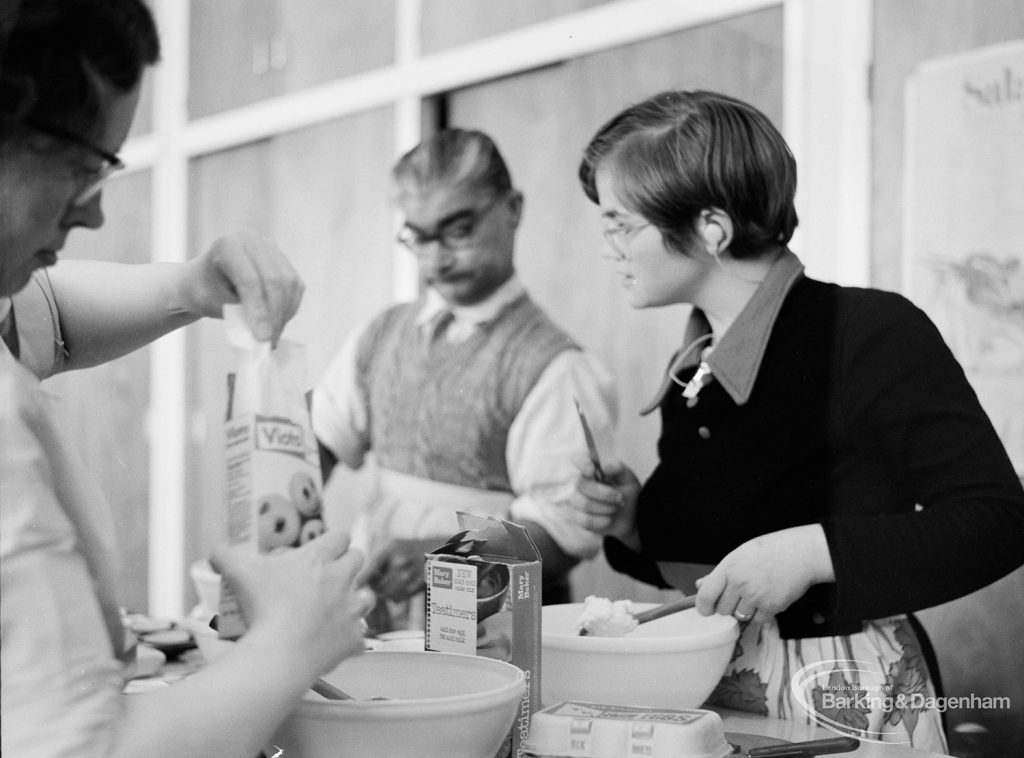 London Borough of Barking Welfare Department, Gascoigne Training Centre for Adults, showing three members of cookery group mixing cake, 1971