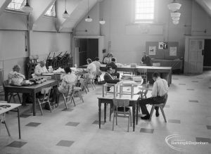 London Borough of Barking Welfare Department, Porters Avenue Occupation Centre, Dagenham, showing main hall with work groups at tables, 1971