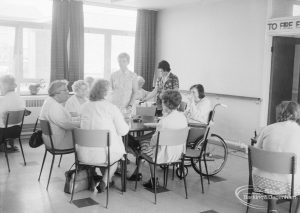 London Borough of Barking Welfare Department, Leys Training Centre Dagenham, showing group of people sitting around table in dining room, 1971