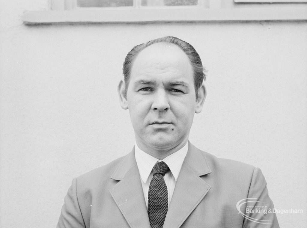 Councillor C J Fairbrass seated outside library [possibly in Barking or Dagenham], 1971