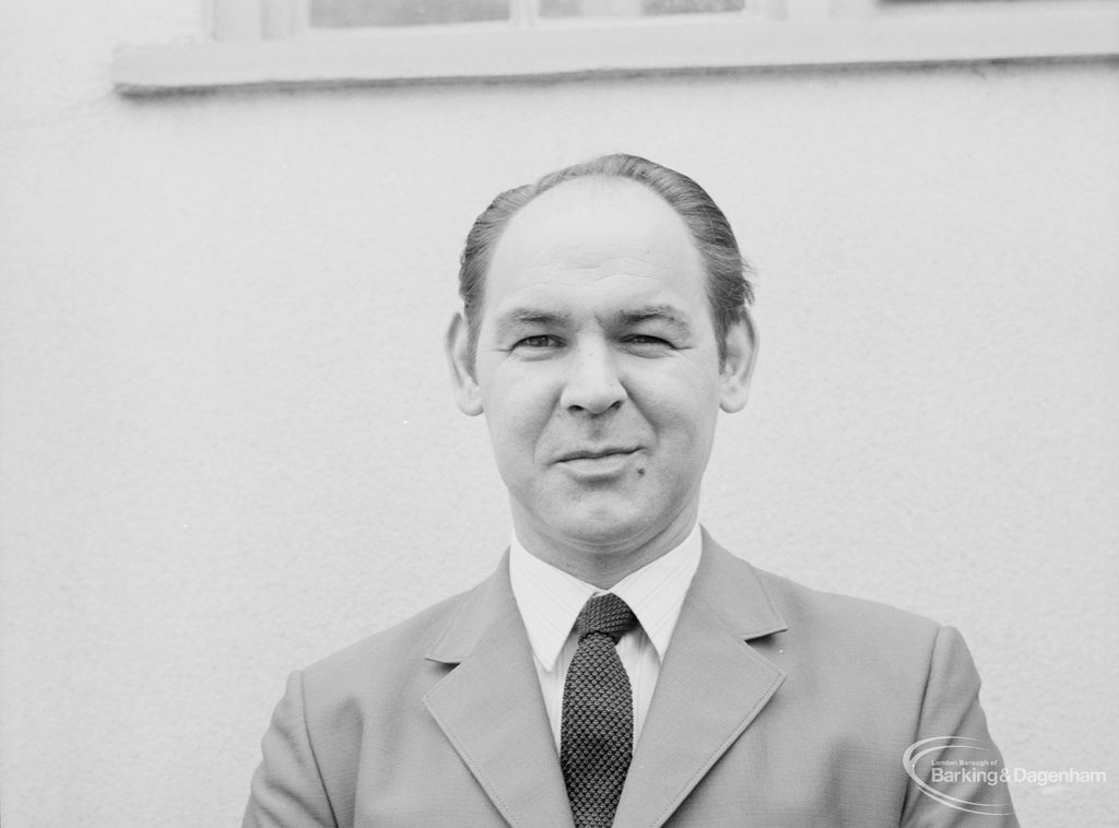 Councillor C J Fairbrass seated outside library [possibly in Barking or Dagenham], 1971