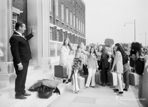 Mayor Councillor Matthew J Spencer waving to Playleader Scheme Majorettes outside Civic Centre, Dagenham prior to their departure for the first International Majorette Competition, 1971