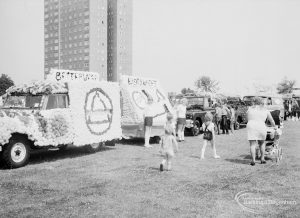 Dagenham Town Show 1971, showing carnival trade vehicles decorated with flowers during judging in Old Dagenham Park, 1971