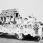 Dagenham Town Show 1971, showing rustic hut with large daisies around sides and mounted on carnival float, during judging in Old Dagenham Park, 1971