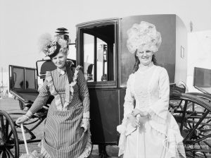 Dagenham Town Show 1971 at Central Park, Dagenham, showing two women in period dress standing in front of Victorian carriage, 1971