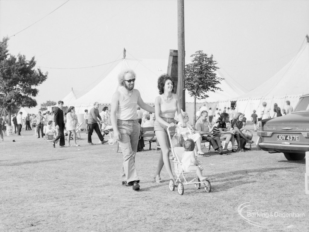 Dagenham Town Show 1971 at Central Park, Dagenham, showing visitors in avenue, including parents wheeling child, 1971