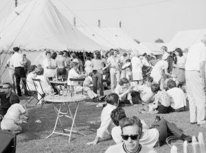 Dagenham Town Show 1971 at Central Park, Dagenham, showing visitors sitting and standing on lawn outside refreshment tent, 1971
