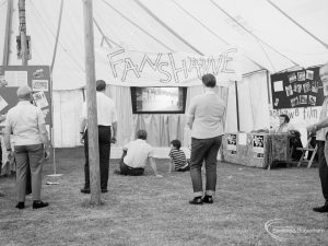 Dagenham Town Show 1971 at Central Park, Dagenham, showing visitors viewing outdoor film at Fanshawe Film Society stand, 1971
