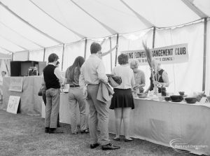 Dagenham Town Show 1971 at Central Park, Dagenham, showing visitors enquiring at the Barking Flower Arrangment Club stand,1971