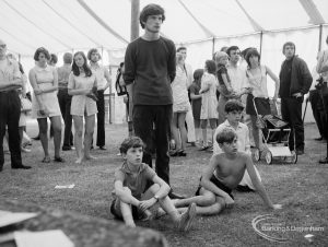 Dagenham Town Show 1971 at Central Park, Dagenham, showing a watching group of visitors including a young man and three children,1971