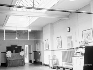 Village Infants School, Church Elm Lane, Dagenham interior [closed 23 July 1971], showing end of hall, top lighted and with radiator and clock, 1971