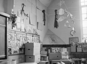 Village Infants School, Church Elm Lane, Dagenham interior [closed 23 July 1971], showing room [possibly main hall] with packing cases and pyramidal feature in corner rising half way to roof, 1971