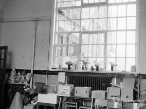 Village Infants School, Church Elm Lane, Dagenham interior [closed 23 July 1971], showing room [possibly main hall] with large window above shelving and packing-up in progress, 1971