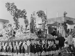 Assembly and departure of Barking Carnival 1971 from Mayesbrook Park, showing a prize winning ladies float, featuring women in traditional costume on a floral float, 1971