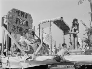 Assembly and departure of Barking Carnival 1971 from Mayesbrook Park, showing float entitled ‘The Four Seasons’ with a carnival queen and group of children, 1971