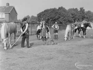 Barking Carnival 1971 from Mayesbrook Park, showing  people dressed as Cowboys and Native Americans in the paddock with horses, 1971