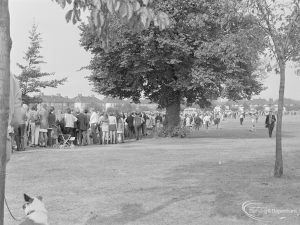 Barking Carnival 1971 from Mayesbrook Park, showing crowd of spectators lining field to watch the parade, 1971