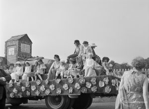 Barking Carnival 1971 from Mayesbrook Park, showing float decorated with flowers, carrying children dressed in costumes, 1971