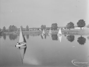Distant view of four sailing boats in open water at the Sailing Regatta in Mayesbrook Park, Dagenham, 1971