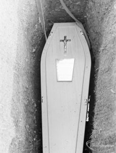 Funeral of Alderman Denis O’Dwyer KSG, showing coffin with cross and brass plate in grave at Eastbrookend Cemetery, Dagenham, 1971
