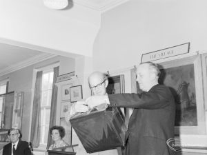 London Borough of Barking Libraries staff, showing presentation of leaving present by Borough Librarian E W McManus to Chief Cataloguer Ernest Thorogood, 1971