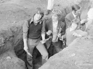 Barking Abbey recent excavation, showing Ministry Official and youngsters in trench holding medieval bones and skull, 1971