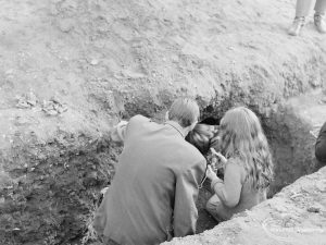 Barking Abbey recent excavation, showing Ministry Official and others, excavating hole in side of trench, 1971