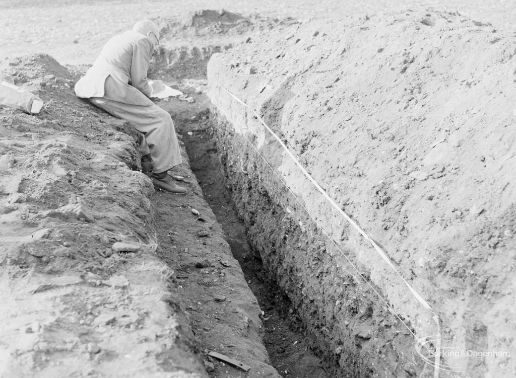 Barking Abbey recent excavation, showing Ministry of Environment official measuring trench on north-west, 1971