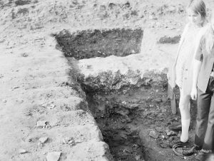 Barking Abbey recent excavation, showing young excavators standing in shallow trench, 1971