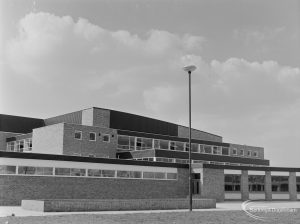 New Dagenham Swimming Pool at Becontree Heath, showing central range from south-east, and with lighting column, 1972