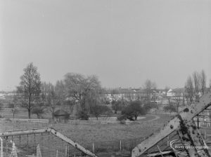 Housing in Dagenham, showing view from railway footbridge north-north-east towards willow tree in Pondfield Park, 1972