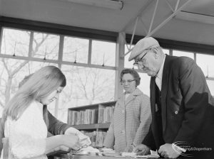 Bespectacled man waiting for his bus permit in Children’s Library at Rectory Library, Dagenham, 1972