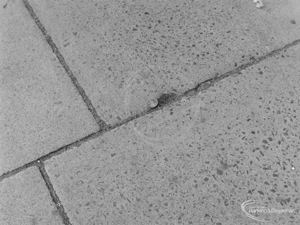 Highways, showing slight depression in pavement outside Police Station, Ripple Road, Barking, with 2p coin to give sense of scale, 1972