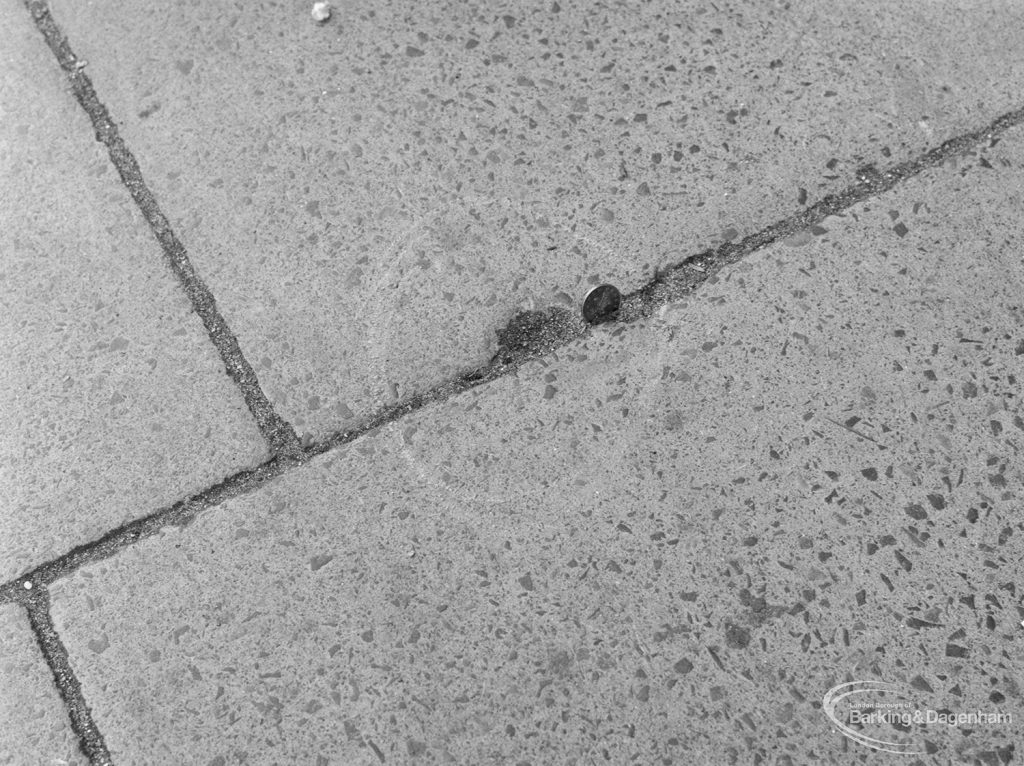 Highways, showing slight depression in pavement outside Police Station, Ripple Road, Barking, with 2p coin to give sense of scale, 1972