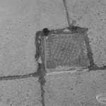 Highways, showing small metal cover in pavement outside Police Station, Ripple Road, Barking, with 2p coin to give sense of scale, 1972