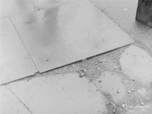 Defective paving in Wood Lane, Dagenham, north side near the Cherry Tree Public House, with 2p coin to give sense of scale, 1972